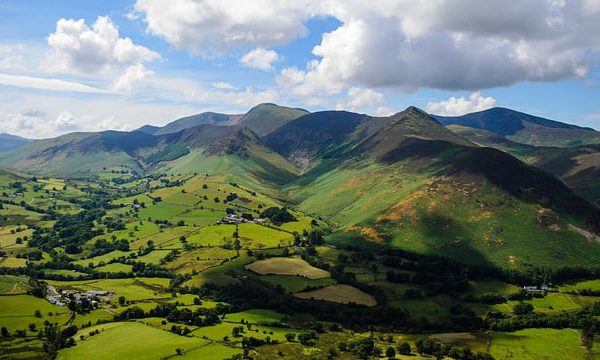 Landscape photograph of the rolling green Lake District mountains in the sunshine